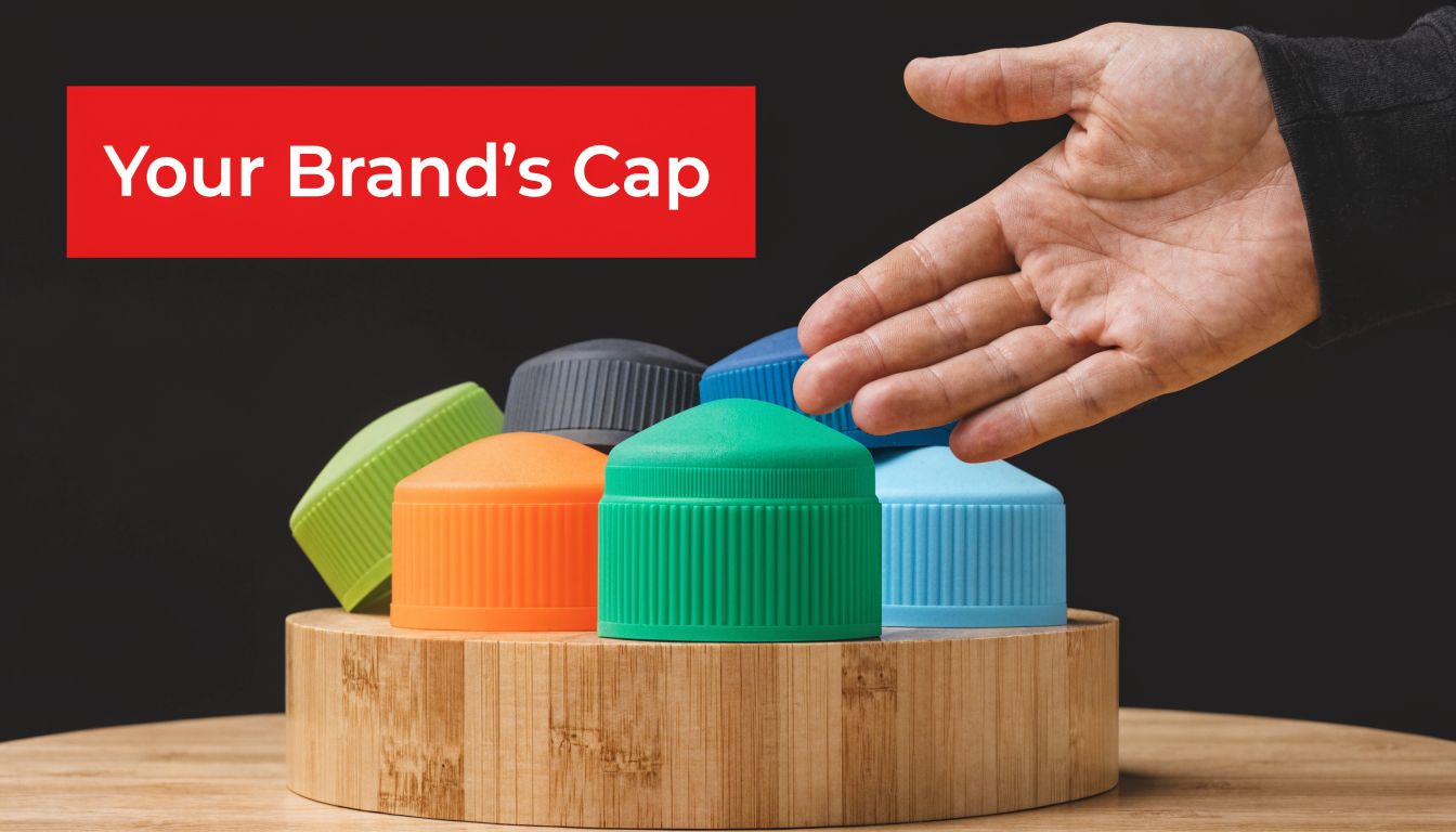 A hand gesturing towards a collection of colorful plastic bottle caps arranged on a wooden platform.