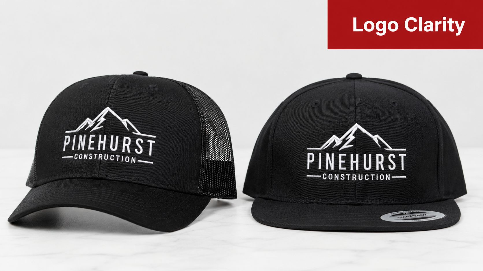 A black mesh trucker hat and a black structured snapback hat, both featuring Pinehurst Construction embroidery.